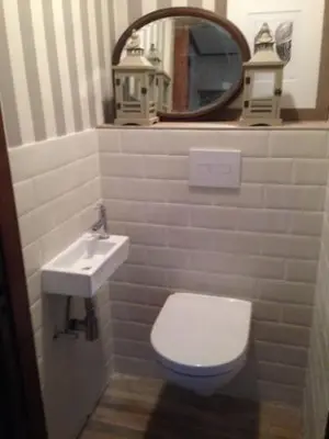 a bathroom with a toilet and a sink and a mirror at Zeeduin - fantastisch uitzicht op zee in Bergen aan Zee