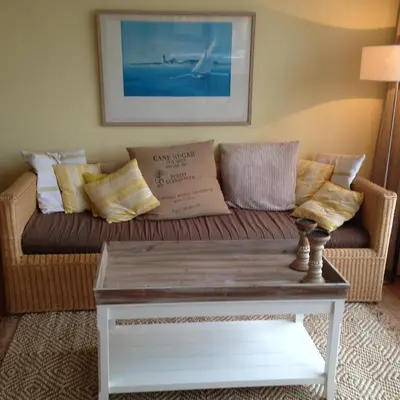 a living room with a couch and a coffee table at Zeeduin - fantastisch uitzicht op zee in Bergen aan Zee