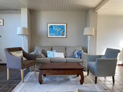 a living room with a couch and two chairs at Pacific, spectacular seaview in Bergen aan Zee