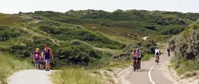 a group of people riding bikes on a dirt road at Bungalow 6p in Noordwijk
