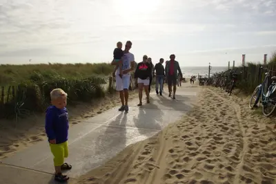 a group of people walking on the beach at Bungalow 6p in Noordwijk