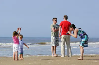 a group of people standing on the beach at Bungalow 6p in Noordwijk