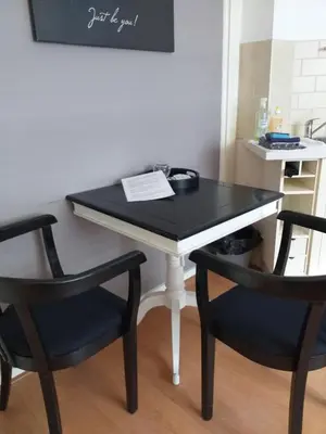 a black and white table with two chairs and a desk at El Sol Zandvoort in Zandvoort