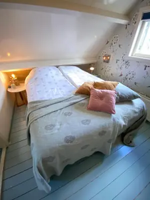 a bed with two pillows on it in a bedroom at Romantic Dutch hideaway in Jisp