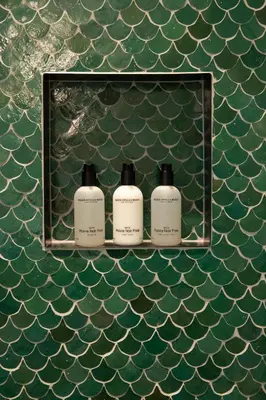 three bottles of soap on a shelf on the wall at Parkhotel Abcoude in Abcoude