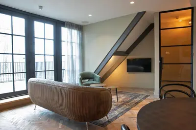 a living room with a couch and a chair at Parkhotel Abcoude in Abcoude