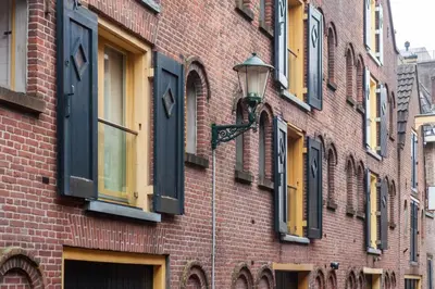 a brick building with windows and a street light at King's Inn City Hotel Alkmaar in Alkmaar