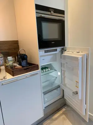 an open refrigerator with a tv on top of it at Leidse Square 5 star Luxury Apartment in Amsterdam