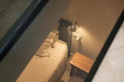 a small room with a bed and a table at Leidse Square 5 star Luxury Apartment in Amsterdam