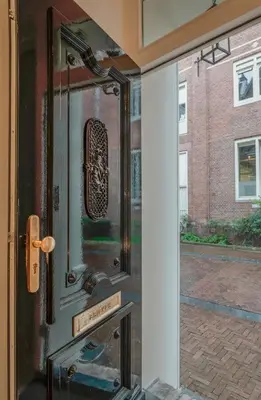 a glass door with a reflection of a building at Leidse Square 5 star Luxury Apartment in Amsterdam