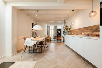 a kitchen and dining room with a table and chairs at Leidse Square 5 star Luxury Apartment in Amsterdam