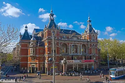 a large red brick building with people in front of it at Leidse Square 5 star Luxury Apartment in Amsterdam