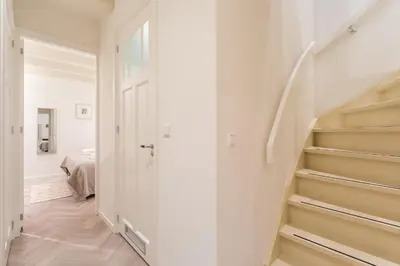 a hallway with stairs leading to a bedroom at Leidse Square 5 star Luxury Apartment in Amsterdam