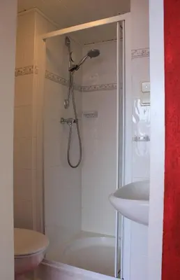 a bathroom with a shower and a sink at Kerstins Bed and Breakfast in Egmond aan Zee