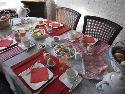 a table with a table cloth with food on it at Kerstins Bed and Breakfast in Egmond aan Zee