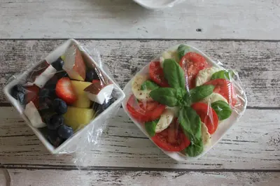 two plastic containers of fruit and vegetables on a table at Kerstins Bed and Breakfast in Egmond aan Zee