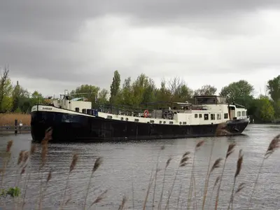 a boat in the water on a river at Hotelboat Sarah in Amsterdam