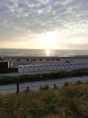 a view of the beach with the ocean in the background at Zomerhuis Simoons in Egmond aan Zee
