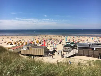 a beach with a large crowd of people at Zomerhuis Simoons in Egmond aan Zee