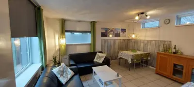 a living room with a couch and a table at Zomerhuis Simoons in Egmond aan Zee
