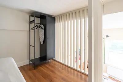 a room with white vertical blinds and a closet at Amsterdam Dockside Flats in Amsterdam