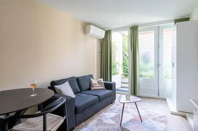 a living room with a couch and a table at Amsterdam Dockside Flats in Amsterdam