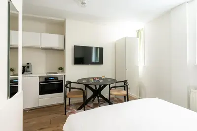 a small kitchen with a table in a room at Amsterdam Dockside Flats in Amsterdam