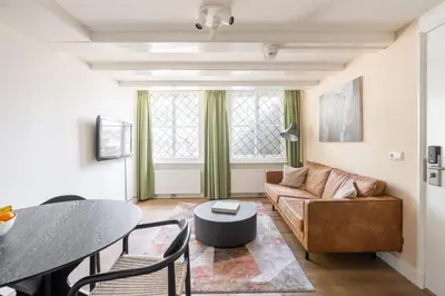 a living room with a couch and a table at Amsterdam Dockside Flats in Amsterdam
