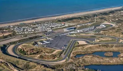 an aerial view of a parking lot next to the ocean at Queens Beachhouse in Zandvoort