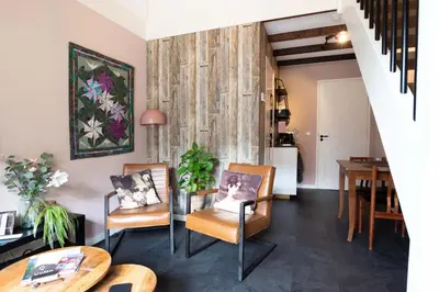 a living room with two chairs and a table at B&B De Hoffstal in Sassenheim
