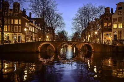 a bridge over a river in a city at night at B&B De Hoffstal in Sassenheim