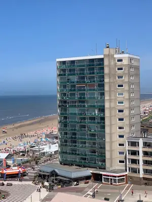 a tall building with a beach in front of it at Happy Beach Apartment in Zandvoort