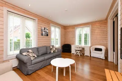 a living room with a couch and a table at The Black House - Luxurious Holiday Villa Zeewolde in Zeewolde