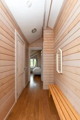 a room with a wooden wall with a bench in it at The Black House - Luxurious Holiday Villa Zeewolde in Zeewolde