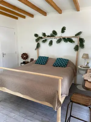 a bedroom with a large bed with plants on the wall at Queens Romantic Beachhouse in Zandvoort
