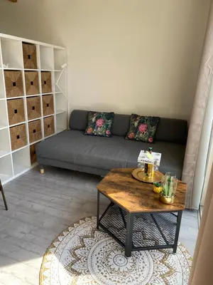a living room with a couch and a coffee table at Queens Romantic Beachhouse in Zandvoort
