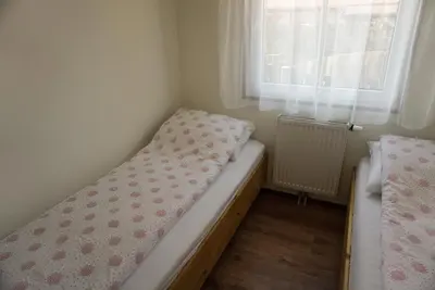 a small bedroom with a bed and a window at Modern chalet at holiday park in Opmeer near Amsterdam in Opmeer