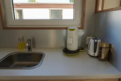 a kitchen counter with a sink next to a sink at Modern chalet at holiday park in Opmeer near Amsterdam in Opmeer
