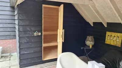 a wooden door on the side of a house at appartement - sauna - natuur - Utrecht in Soest