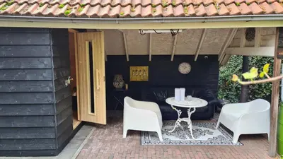 a patio with a table and chairs on a patio at appartement - sauna - natuur - Utrecht in Soest