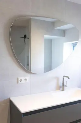 a bathroom with a sink and a mirror at Appartement Spoorklokken in Bergen aan Zee
