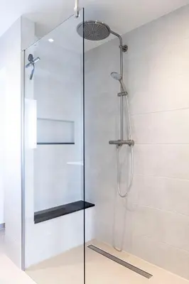 a shower with a glass door in a bathroom at Appartement Spoorklokken in Bergen aan Zee
