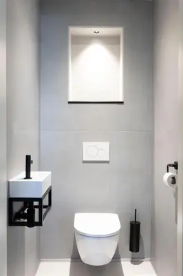 a bathroom with a white toilet and a sink at Appartement Spoorklokken in Bergen aan Zee