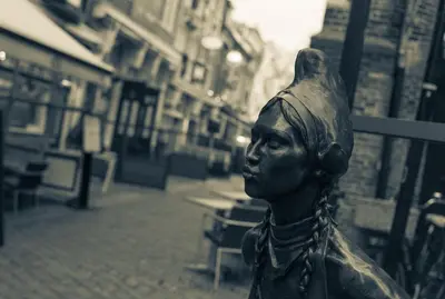 a statue of a bust of a woman on a street at RITCH Aparthotel Alkmaar in Alkmaar