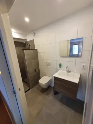 a bathroom with a toilet and a sink at Studio Noordzee in Zandvoort