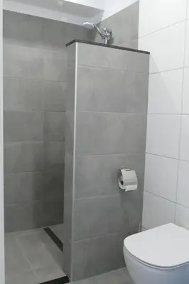 a bathroom with a toilet and a shower at Studio Noordzee in Zandvoort