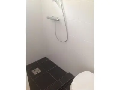 a bathroom with a shower with a toilet at Beach House Arina in Egmond aan Zee