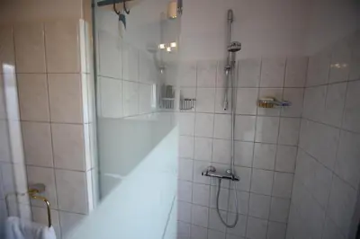 a bathroom with a shower with a glass door at Deluxe STUDIO-appartement Heemstede Zandvoort in Heemstede
