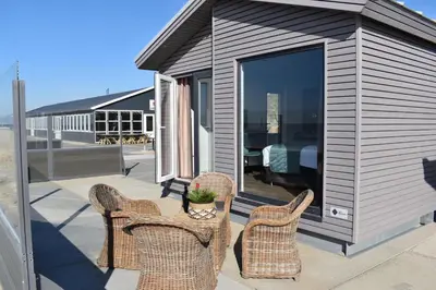 a group of chairs and a table on a patio at STRAND 21 hotelchalets in Zandvoort
