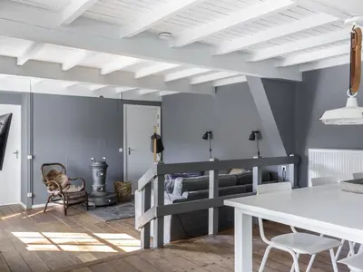 a living room with a bunk bed and a table at Farmhouse in Groet near sea and forest in Groet